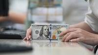 Dollar slips against dong