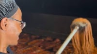 Woman uses mop to apply BBQ sauce on smoked meat; netizens say, 'That’s not even sanitary'