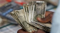 Rupee weakens slightly, broad dollar softness cushions pressure