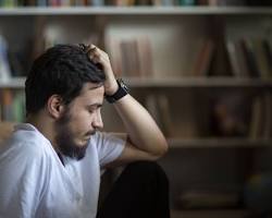 Gambar person with a troubled expression, reflecting mental distress and regret