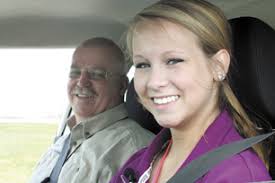 Ron Thayer, a driving instructor at the Ohio Peace Officers Training Academy in London, accompanies West Jefferson junior Alyssa Jacobs during an exercise ... - girl-and-instructor-web