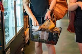 Consumers pulled back on spending in July in the face of continuing price pressures