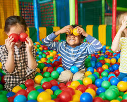 Children happily playing in an indoor playgroundの画像