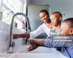 Image of family washing their hands together