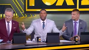 NFL Controversy: Michael Strahan and Fans React to Lamar Jackson Roughing the Passer Call