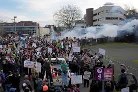 Federal officers use crowd control munitions as demonstrators protest outside Portland ICE building