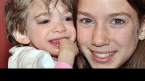 Brooke Greenberg, left, at age 16, is held by younger sister Carly, 13, in this May 11, 2010, photo. Times Online/GDA Photo Service/Newscom - nc_brooke_carly_greenberg_ll_131029_v33x16_16x9_992