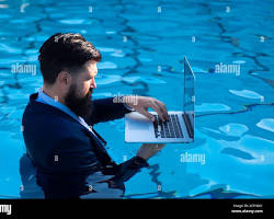Image of person relaxing in a pool with a laptop