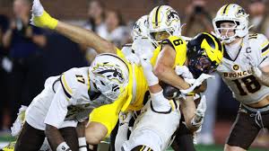 College football players competing during a ranked matchup