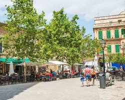 Image of Manacor's central plaza with cafes and shops