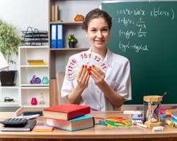 Image of teacher holding up reallife objects to illustrate vocabulary words