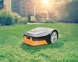 Изображение: robotic lawnmower cutting grass in a yard