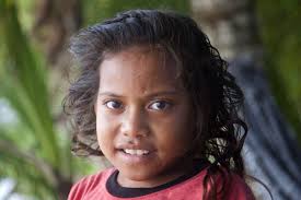 Purchase picture: Young girl from Tuvalu posing for a picture under palm trees - tuvaluan-people10