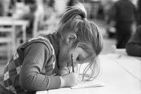 Schoolchildren practicing handwriting in a classroom