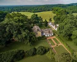 Image of James Monroe hosting guests at Highland, with a view of the Blue Ridge Mountains in the background.