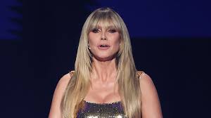 Heidi Klum looks incredible in a metallic gold gown as she joins lilac suited Robbie Williams and glam Nicole Scherzinger at star-studded 2026 World Cup draw in Washington D.C.