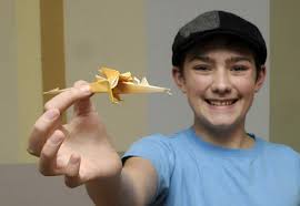 Matt Gade | The Grand Rapids PressTouch of art: Thirteen-year-old Liam Clark has become a master of origami. He shows off a dragon he&#39;s made. - 10472142-large