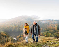 Image of Elderly couple hiking in nature