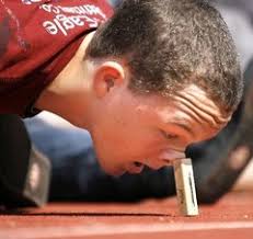 Mandeville High student Erik Henning learns about center of body mass as he tries to tip over a block of wood using his nose. - egg-drop-wood-blockjpg-01e0ef1688c22833_medium