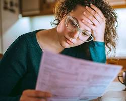 Image of person looking stressed while looking at rent prices