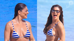 Fotos: Juliana Paes ostenta barriga sarada em biquíni listrado e curte dia de praia com o marido; fotos