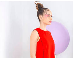 Image of woman in a dress with a subtle piped neckline