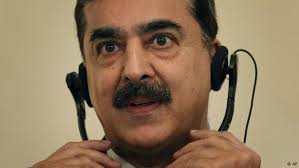 Pakistan's Prime Minister Yusuf Raza Gilani, adjusts his head phone, ...