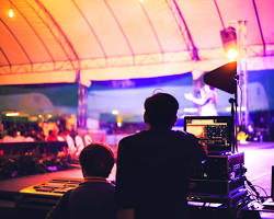 Image of outdoor event with a generator providing electricity for lights and sound