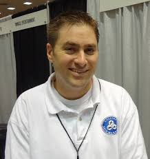 Byron Collins smiling at GAMA Trade Show 2012 So what&#39;s cool about Polyversal is that we&#39;re going to have some boxed versions that include miniatures from ... - byronCollins