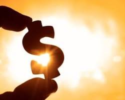 Image of someone holding a dollar sign with a California sunset in the background