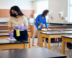 School cleaners cleaning a classroom