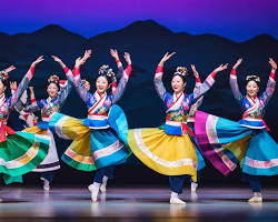 vibrant performance of Korean traditional music and dance, showcasing colorful costumes and instruments 이미지