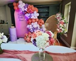Image of Backdrop with props like balloons, flowers, signs, furniture
