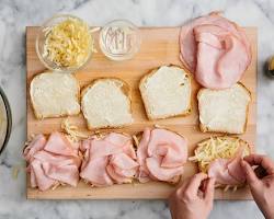 someone assembling a sandwich