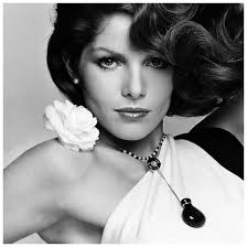 Model Lois Chiles, wearing a black and white rayon crepe one-shouldered dress by Halston with a fresh camellia flower on the shoulder and a onyx and pearl ... - model-lois-chiles-wearing-a-black-and-white-rayon-crepe-one-shouldered-dress-by-halston-with-a-fresh-camellia-flower-on-the-shoulder-and-a-onyx-and-pearl-necklace-with-bottle-pendant-by