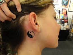 A basic Yin Yang tattoo can be as big or small as you want. Check out this neat Yin Yang tattoo that the lady shows off behind her ear. - yin-to-the-yang