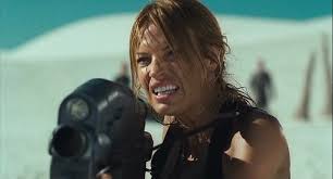 Lola Beck (Jolene Blalock) opens fire with the Morita variant. - 500px-ST3_05