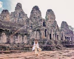 Traveler walking through the ancient ruins of Angkor Wat