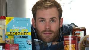 Jonathan Lemieux, author of &#39;Survivre avec une poignee de change&#39; (Surviving on a Handfull of Change), poses for a photograph with a copy of the book and ... - image