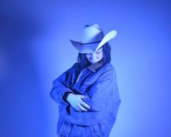 Image of person wearing a cowboy hat and boots