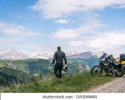 Immagine di motorcycle rider enjoying the view of the Alps