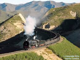 Image result for train in a green hill tunnel with clouds