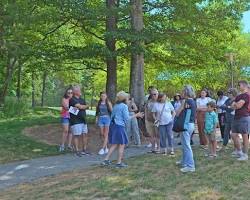 Image of Visitors engaged in an interactive exhibit at Montpelier, learning about James Madison's contributions to American history