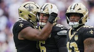Raiders players walking onto the field in New Orleans