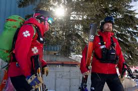 Ski patroller preparing for a winter shift before sunrise at a Colorado ski resort