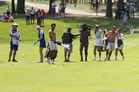 WARNING, shirtless caddies: Alison Lee holes wedge shot at Solheim Cup and 
then the unthinkable happened