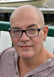 Head shot of Kevin Crawford, bald, wearing glasses, gray shirt He called his stage work &quot;technically only a hobby.&quot; Rather, he saw himself as an academic, ... - kevin_crawford