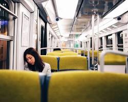 Image of Person feeling tired while traveling in a train