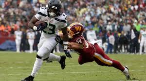 Leo Chenal being attended to after suffering a neck injury during the Commanders-Seahawks game