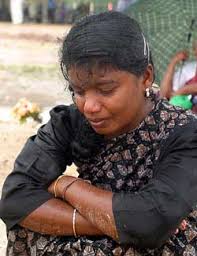 A young Tamil woman mourns at a war cemetery in Kilinochchi, Sri Lanka, on Thursday. Rebels held War Hero Day to honour the nearly 17,700 Tamil Tigers ... - world5